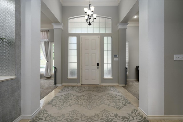 2101 Bois D Arc Dr, Sherman, TX 75092 - carpeted entryway with decorative columns, tile patterned flooring, ornamental molding, a chandelier, and baseboards