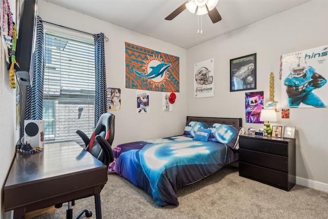 carpeted bedroom featuring a ceiling fan and baseboards