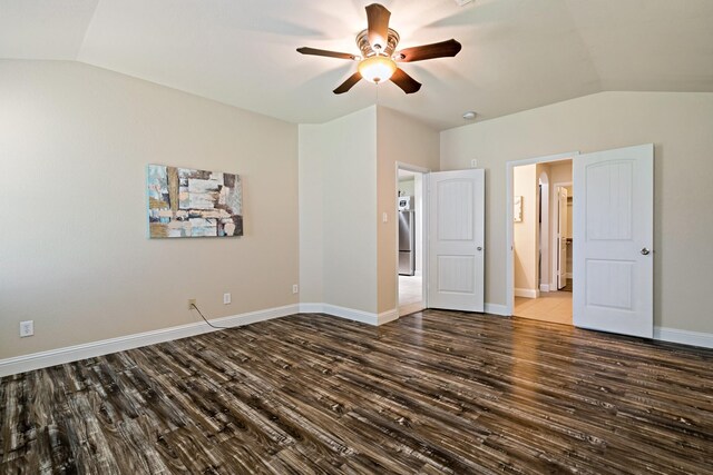 unfurnished bedroom with lofted ceiling, wood finished floors, and baseboards