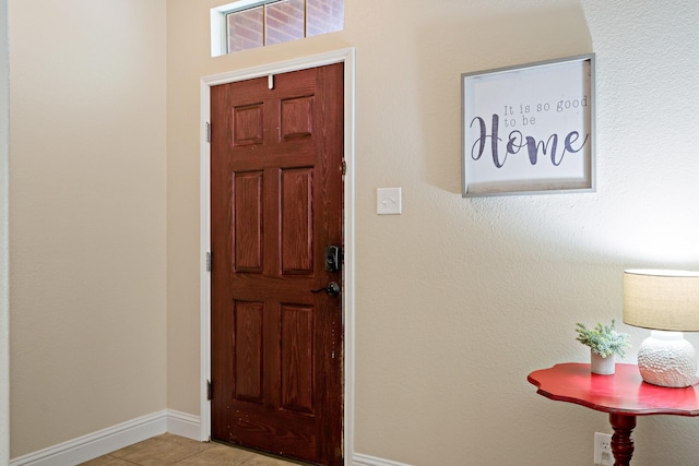 entrance foyer with baseboards and light tile patterned flooring