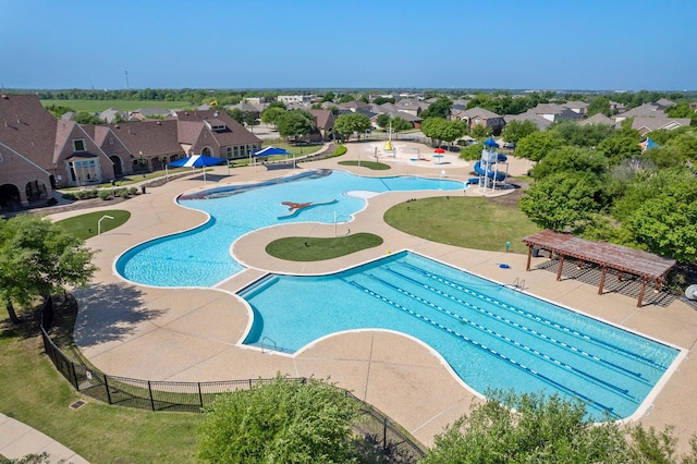 pool with fence and a residential view