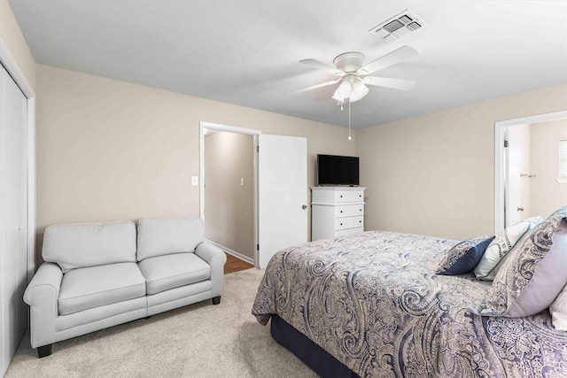 bedroom with a ceiling fan, visible vents, a closet, and carpet flooring