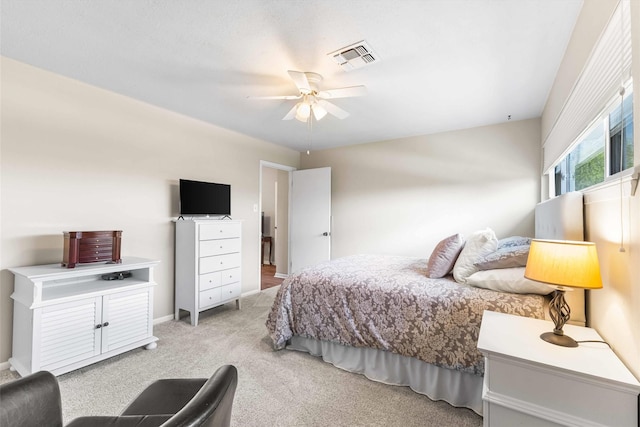 bedroom with light colored carpet, ceiling fan, and visible vents