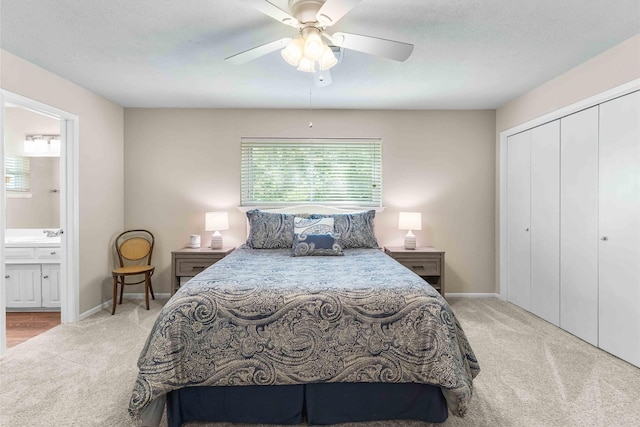 bedroom with a closet, carpet flooring, baseboards, and connected bathroom