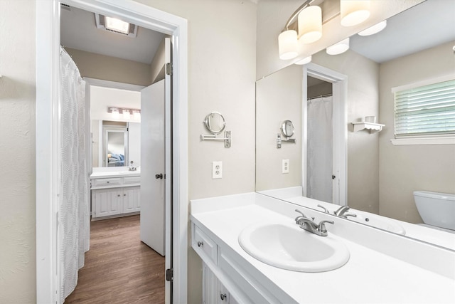 full bath featuring wood finished floors, visible vents, toilet, and vanity