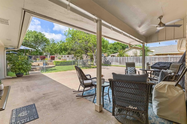 view of patio featuring grilling area, a fenced backyard, a ceiling fan, and visible vents