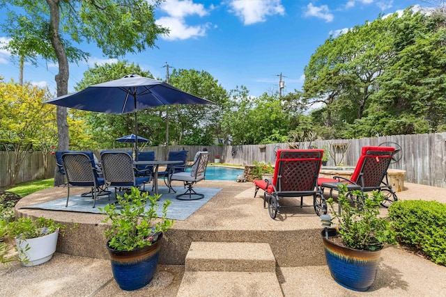 view of patio / terrace with a fenced backyard, a fenced in pool, and outdoor dining space