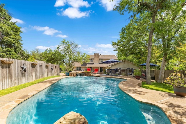 view of swimming pool featuring a patio area, a fenced backyard, and a fenced in pool