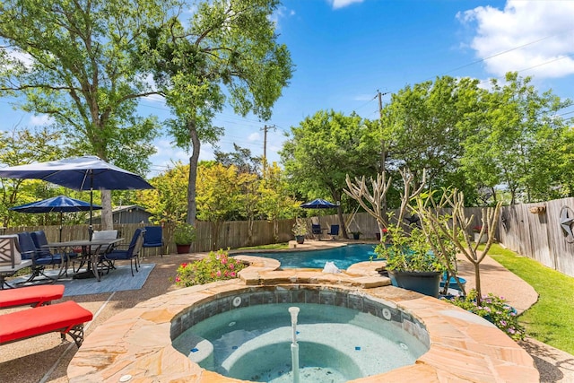 view of swimming pool with a patio area, a fenced in pool, a fenced backyard, and an in ground hot tub
