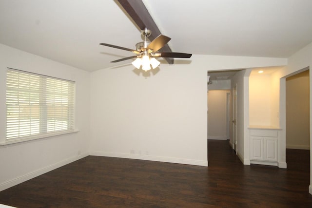 empty room with baseboards, a ceiling fan, vaulted ceiling, and dark wood-type flooring