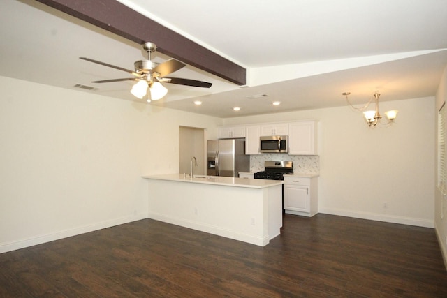 kitchen with a peninsula, tasteful backsplash, visible vents, light countertops, and appliances with stainless steel finishes
