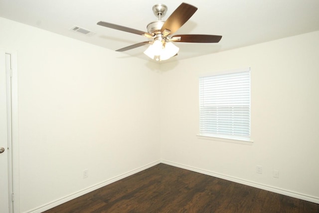 unfurnished room featuring baseboards, a ceiling fan, visible vents, and dark wood-style flooring
