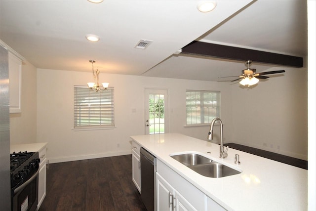 kitchen with white cabinets, stainless steel appliances, light countertops, visible vents, and a sink