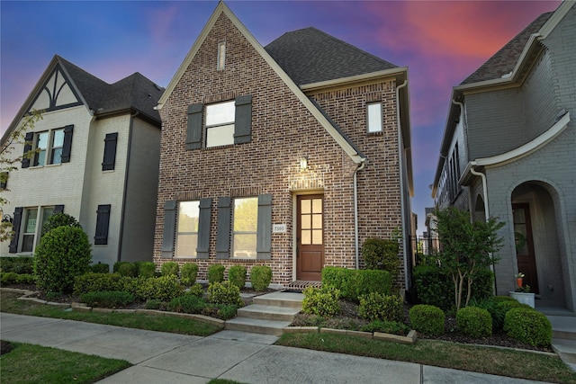 7305 Caladium Dr, Mckinney, TX 75070 - tudor-style house with brick siding and roof with shingles
