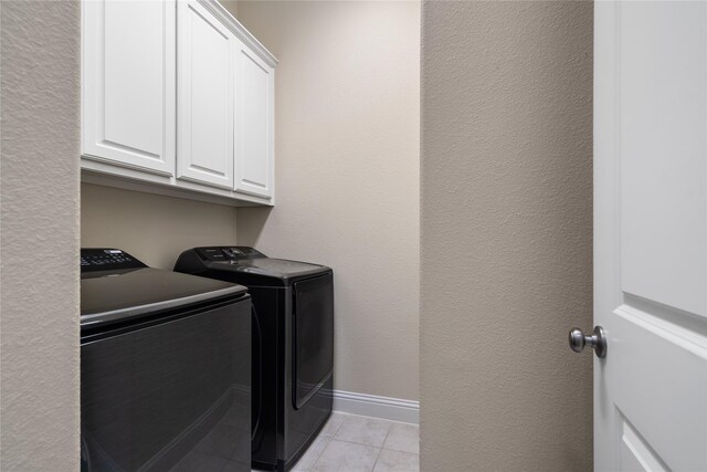 7305 Caladium Dr, Mckinney, TX 75070 - laundry room with washing machine and clothes dryer, cabinet space, light tile patterned flooring, and baseboards