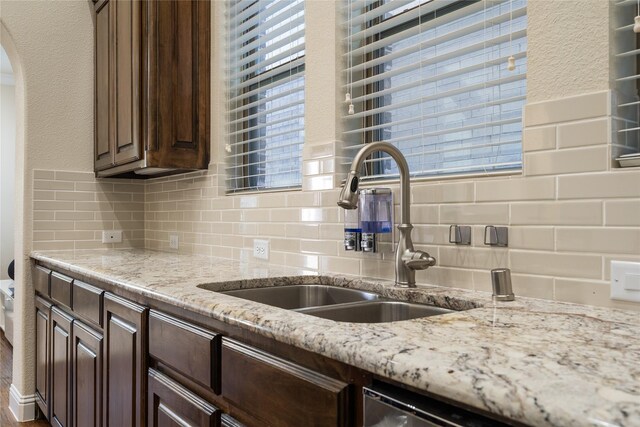 7305 Caladium Dr, Mckinney, TX 75070 - kitchen with a sink, backsplash, and dark brown cabinetry