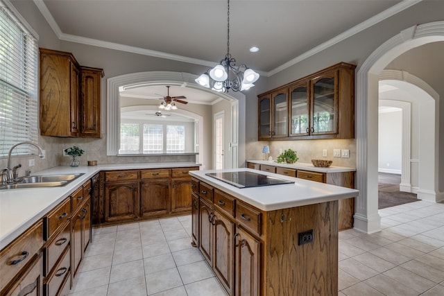 1809 Cotton Mill Dr, Mckinney, TX 75072 - kitchen featuring light tile patterned floors, arched walkways, a sink, black electric stovetop, and tasteful backsplash