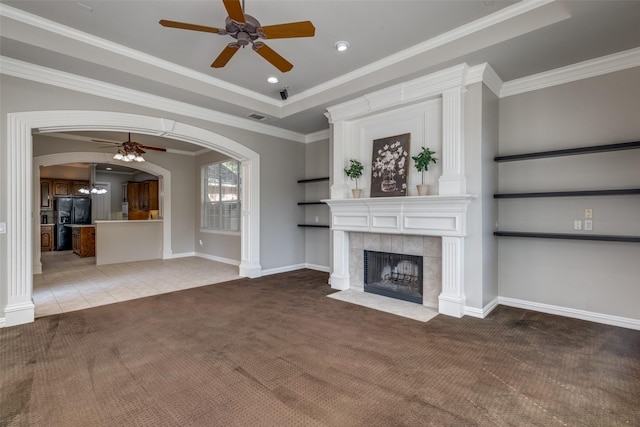 1809 Cotton Mill Dr, Mckinney, TX 75072 - unfurnished living room featuring arched walkways, a tiled fireplace, visible vents, a ceiling fan, and carpet floors