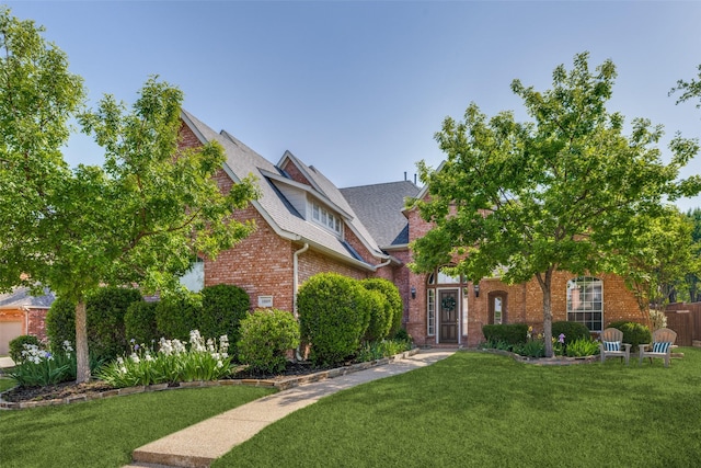 1809 Cotton Mill Dr, Mckinney, TX 75072 - view of front of property with brick siding, roof with shingles, and a front lawn