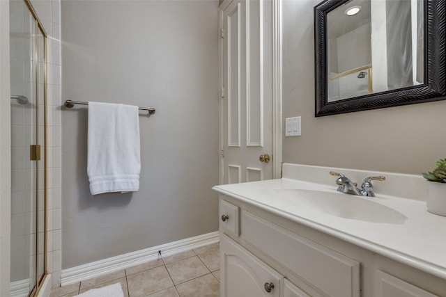 1809 Cotton Mill Dr, Mckinney, TX 75072 - bathroom featuring tile patterned floors, baseboards, vanity, and tiled shower