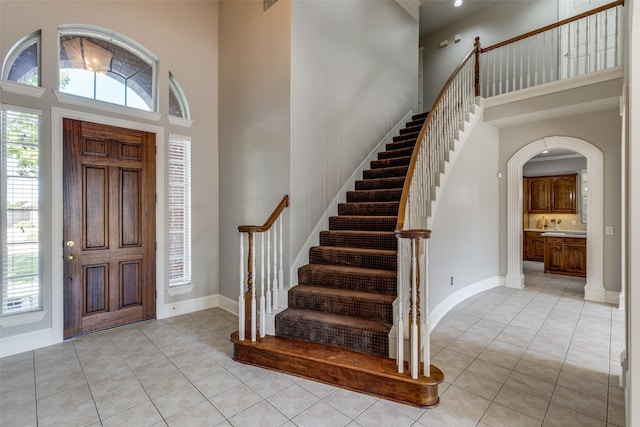 1809 Cotton Mill Dr, Mckinney, TX 75072 - foyer entrance with stairway, a high ceiling, and light tile patterned floors