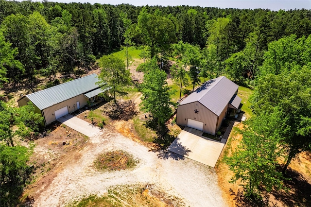 drone / aerial view with a wooded view