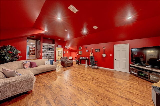 living area with lofted ceiling, wood finished floors, visible vents, and recessed lighting