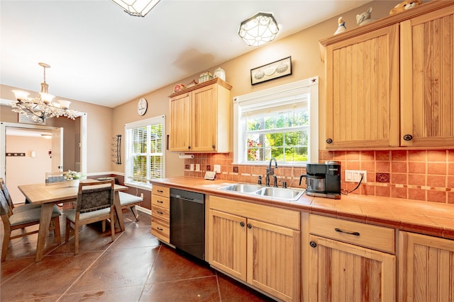 kitchen with light brown cabinetry, dishwasher, tile countertops, a sink, and decorative backsplash