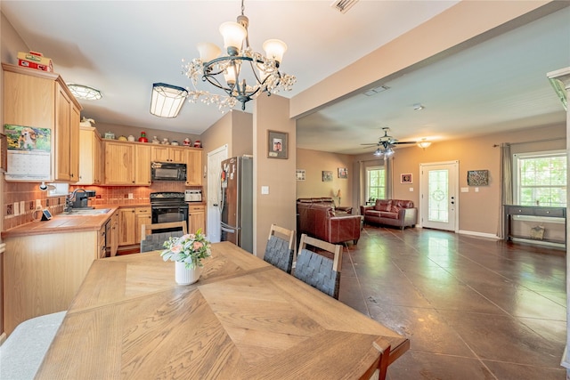 dining area featuring baseboards and ceiling fan with notable chandelier
