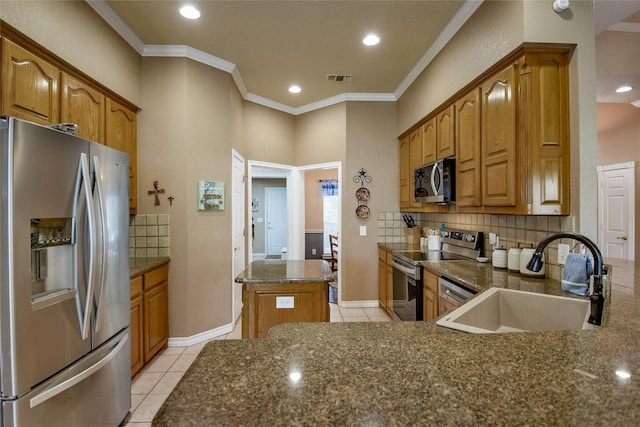 kitchen with visible vents, light tile patterned floors, a sink, decorative backsplash, and appliances with stainless steel finishes