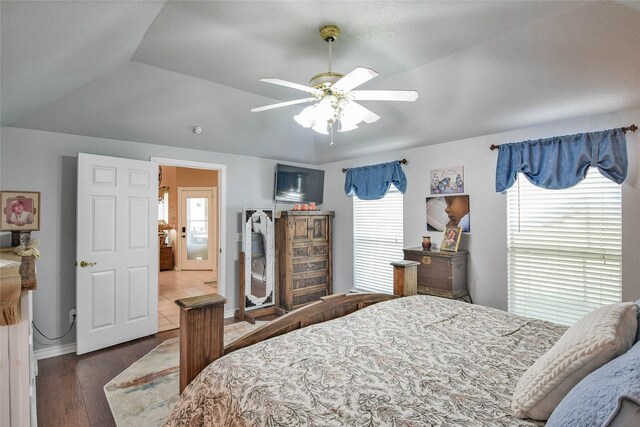 bedroom with baseboards, wood finished floors, ceiling fan, and multiple windows