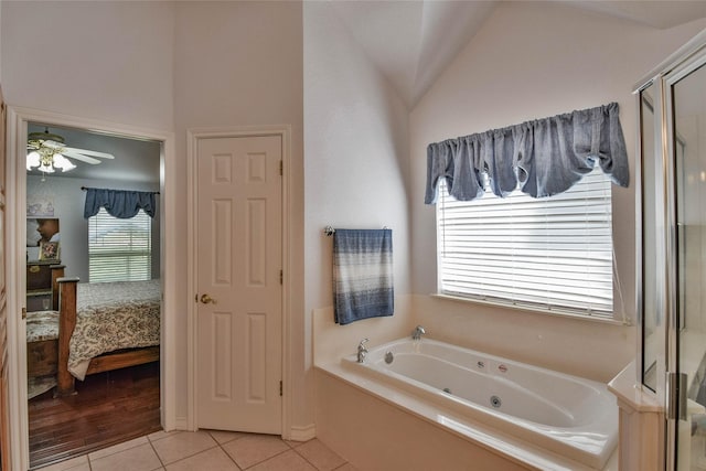 full bathroom featuring ensuite bathroom, a stall shower, ceiling fan, a jetted tub, and tile patterned flooring