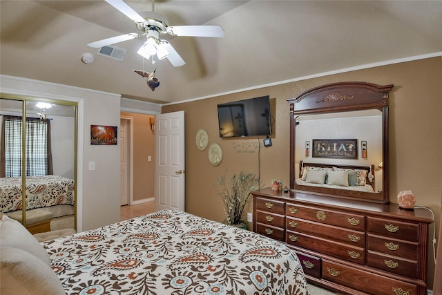 bedroom with vaulted ceiling, visible vents, a ceiling fan, a closet, and ornamental molding