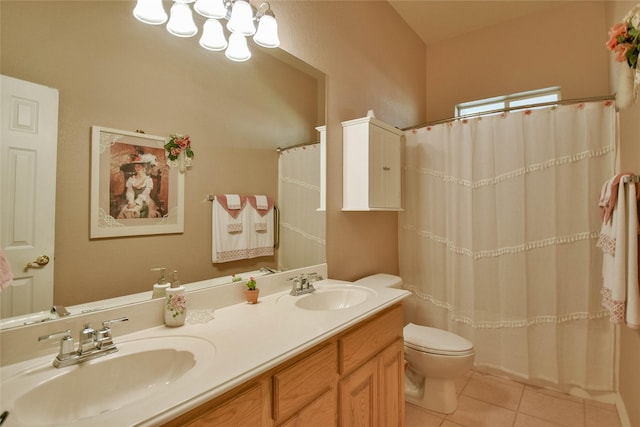 full bathroom with tile patterned flooring, a sink, double vanity, and toilet