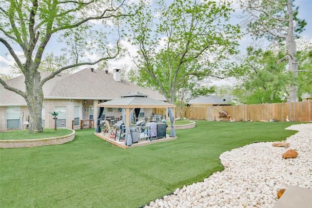 view of yard featuring a fenced backyard and a gazebo