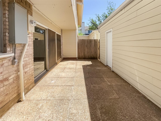 view of side of property featuring a patio area and fence