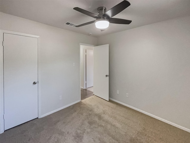 unfurnished bedroom featuring baseboards, visible vents, and carpet flooring