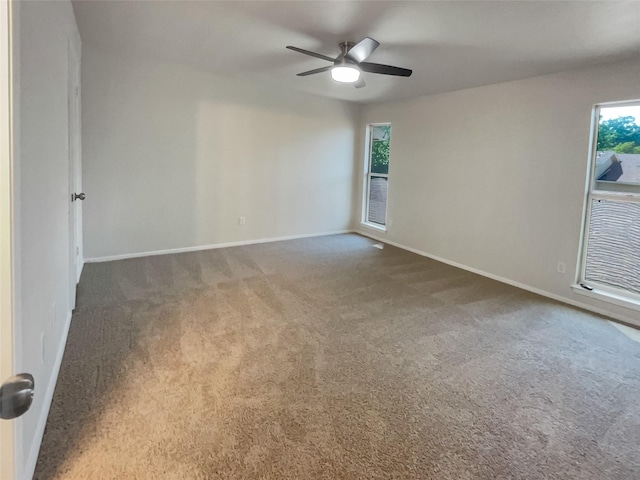 unfurnished room featuring a ceiling fan, baseboards, and carpet