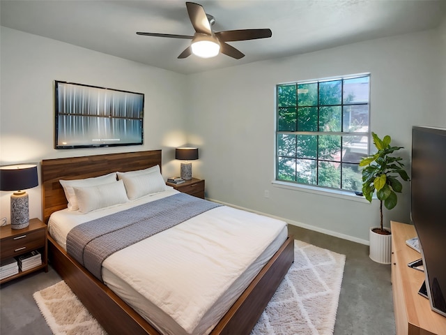 carpeted bedroom with baseboards and ceiling fan
