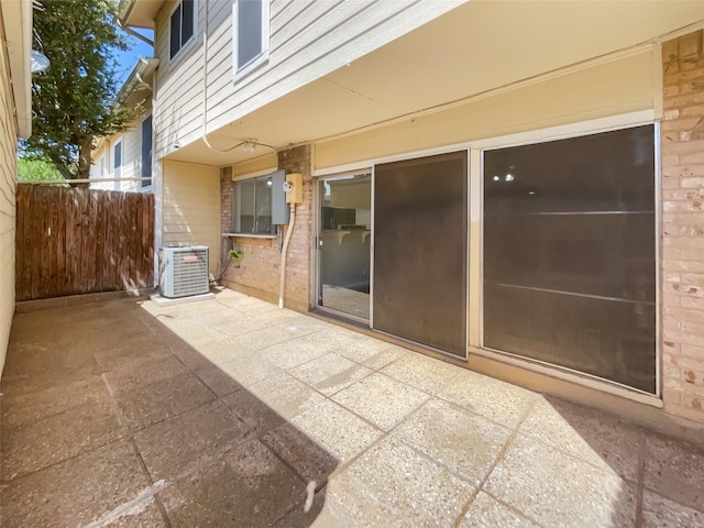 view of patio / terrace with central AC unit and fence