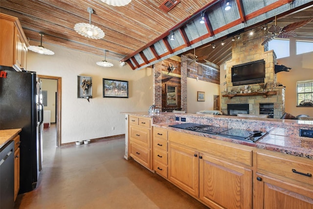 1350 Bennett Rd, Millsap, TX 76066 - kitchen with open floor plan, baseboards, finished concrete flooring, a stone fireplace, and black appliances