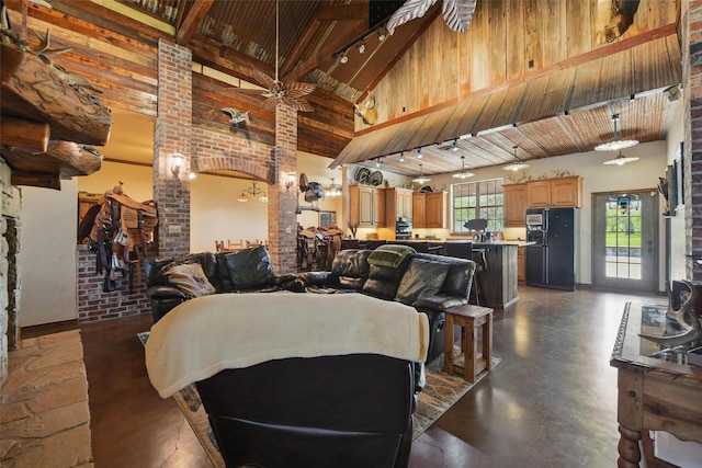 1350 Bennett Rd, Millsap, TX 76066 - living room featuring beamed ceiling, a ceiling fan, concrete floors, wooden ceiling, and high vaulted ceiling