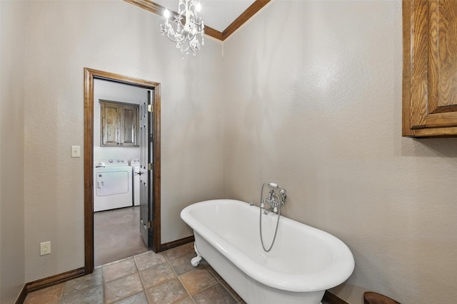 1350 Bennett Rd, Millsap, TX 76066 - bathroom with a soaking tub, washing machine and dryer, baseboards, a notable chandelier, and stone finish flooring