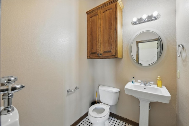 1350 Bennett Rd, Millsap, TX 76066 - bathroom with baseboards, a sink, and toilet
