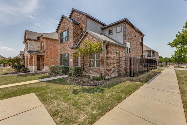 view of home's exterior with brick siding, a yard, and fence