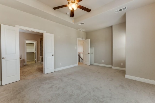 unfurnished bedroom with light carpet, baseboards, and visible vents