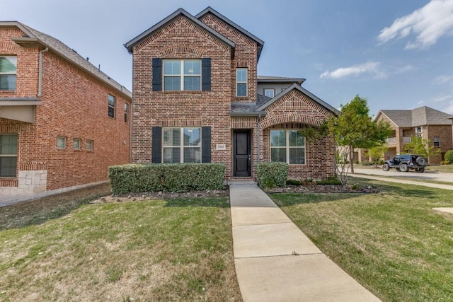 traditional-style house featuring brick siding and a front yard