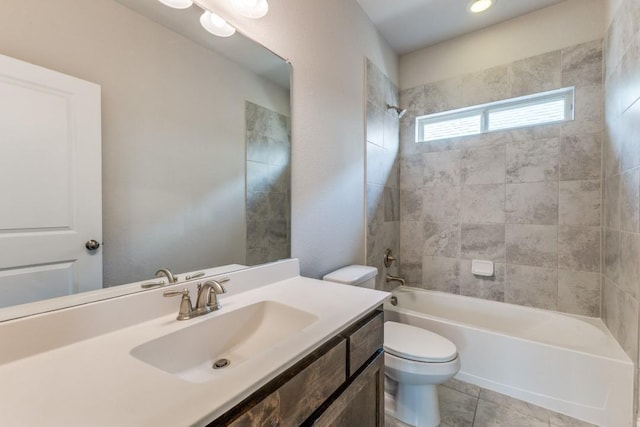 bathroom featuring tile patterned floors, toilet, vanity, and shower / washtub combination
