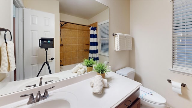 full bath with shower / tub combo, vanity, and toilet