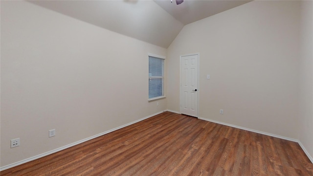 spare room with ceiling fan, baseboards, lofted ceiling, and wood finished floors